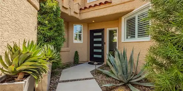 Image 3: A striking modern entryway featuring a segmented c