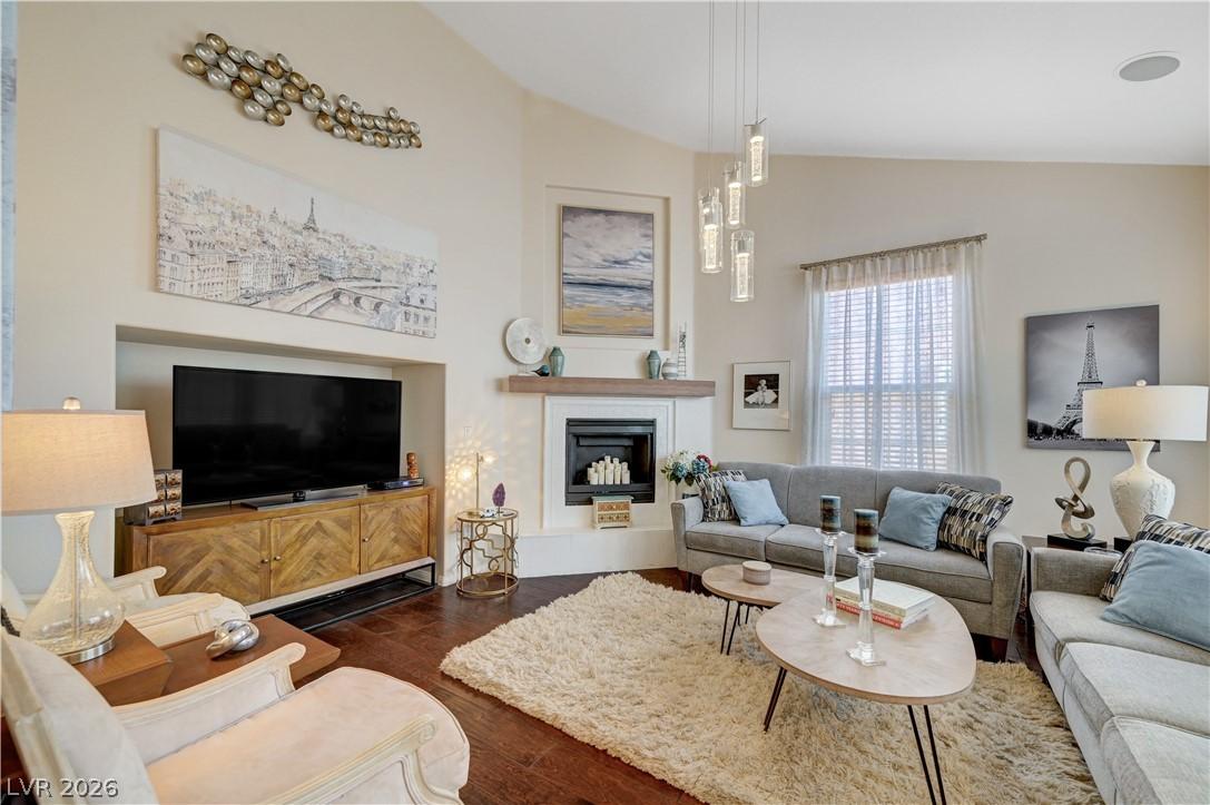 Image 4: Living room featuring dark wood-style floors, a fi