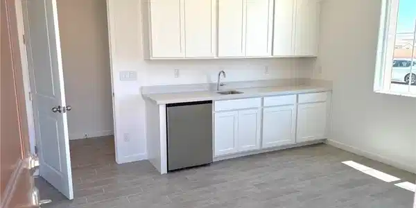 Image 3: Kitchen with white cabinets, stainless steel dishw