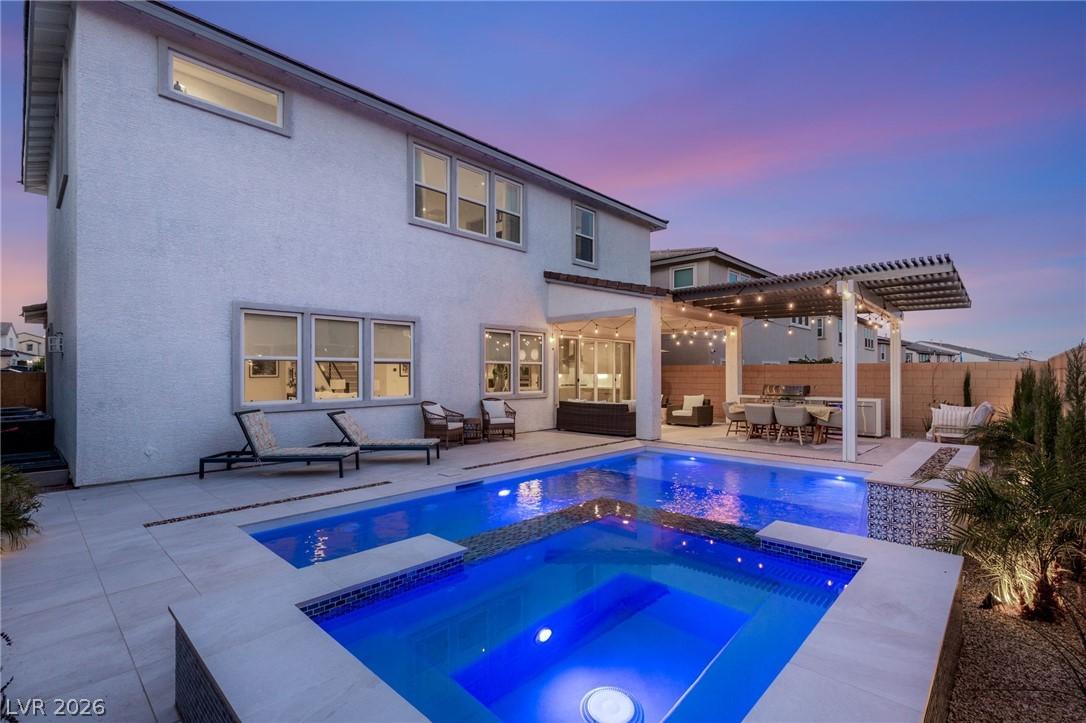 Image 1: An inviting backyard oasis offers a sparkling pool