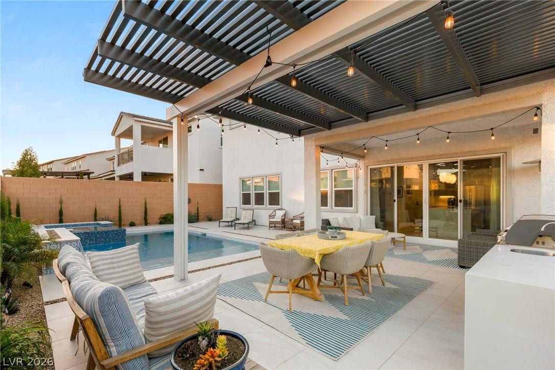 Image 2: An inviting backyard oasis features a shimmering p