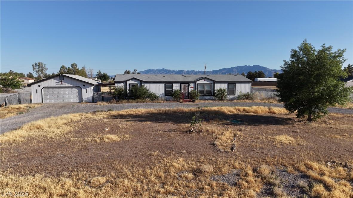 Image 2: A well-maintained manufactured home with a detache