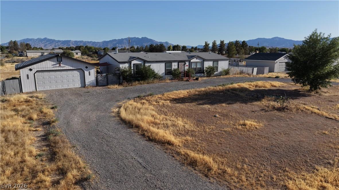 Image 4: A spacious gravel driveway leads to a welcoming ho