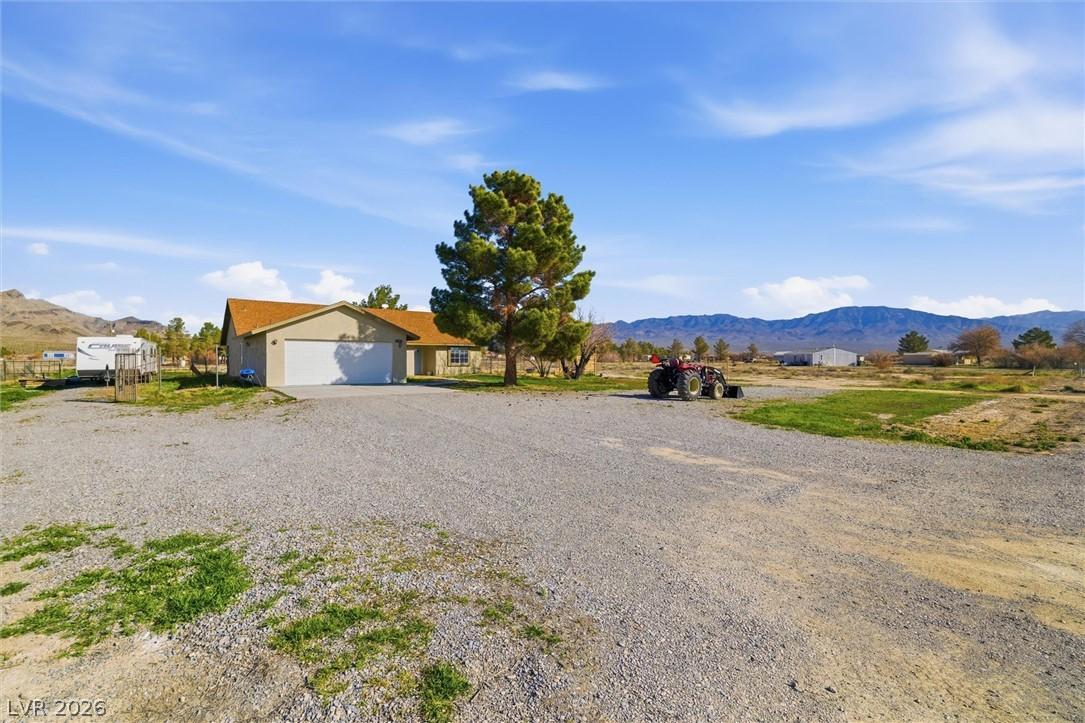 Image 2: A desert oasis with a spacious gravel driveway, of