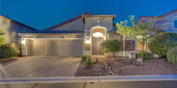 Image 2: An inviting exterior boasts a brick paver driveway