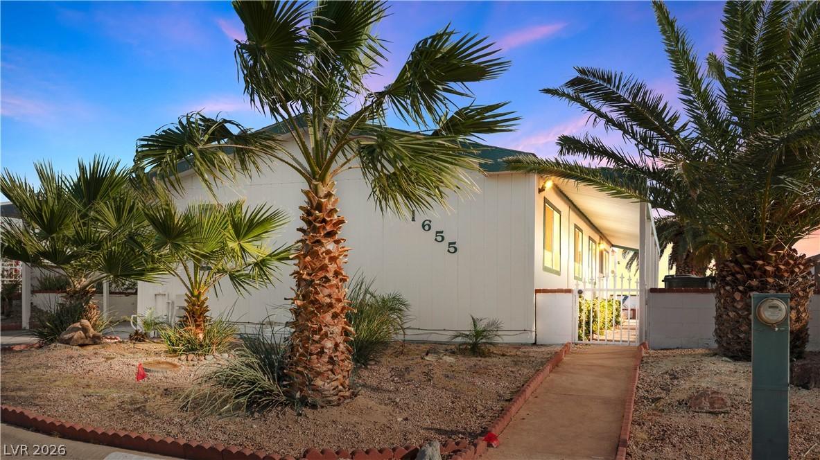 Image 3: View of front of home with a gate to the covered p
