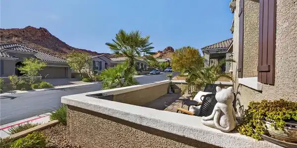 Image 2: An inviting front patio overlooks the quiet neighb