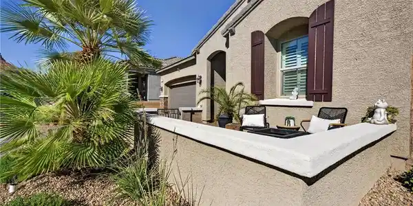 Image 3: An inviting front courtyard with stucco walls high