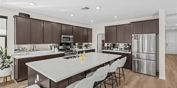 Image 4: An expansive kitchen features a large central isla