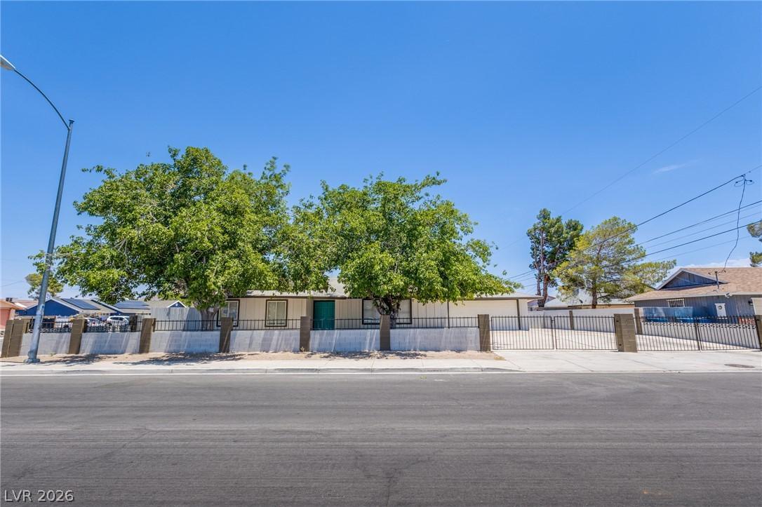 Image 3: A secured property, enclosed by a robust fence and