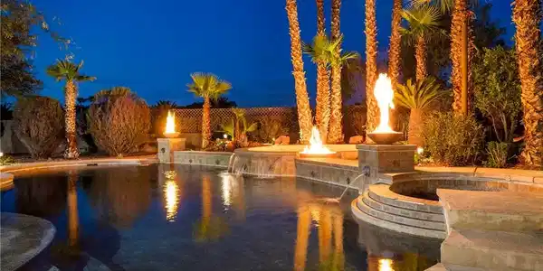 Image 4: Illuminated desert landscaping frames this invitin