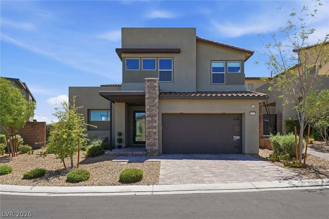 Image 1: A modern facade with a paver driveway complements