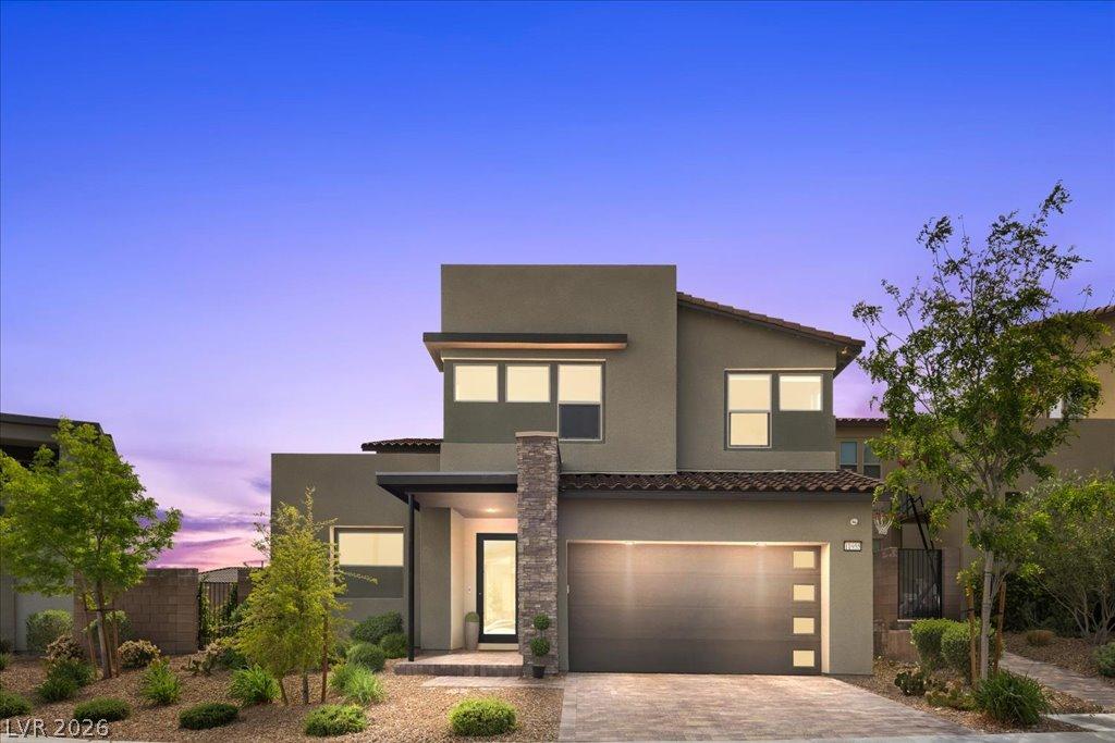 Image 3: Modern desert home with a stylish garage door and