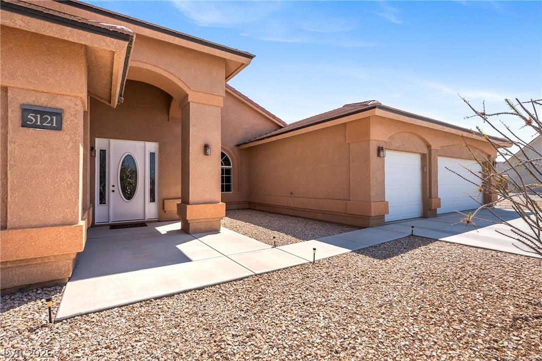 Image 3: A welcoming entry, with a two-car garage, sets the