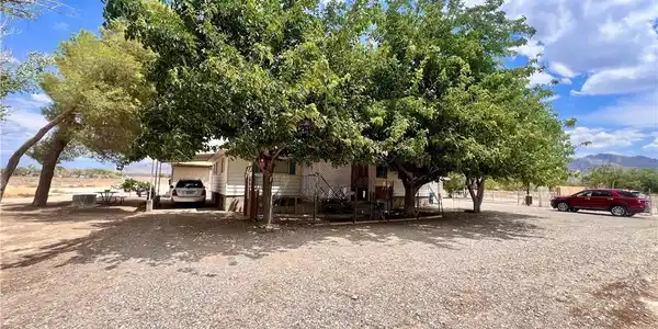 Image 2: Mature trees shade this charming residence set aga