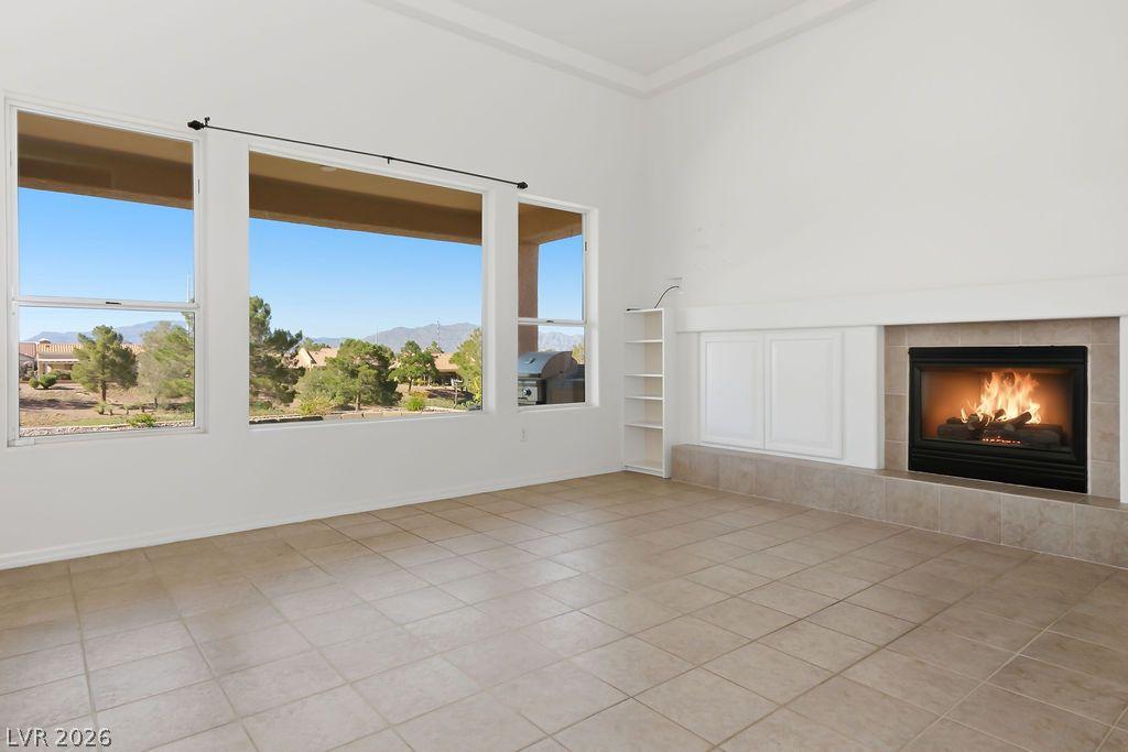 Image 4: Floor-to-ceiling windows and a cozy fireplace crea