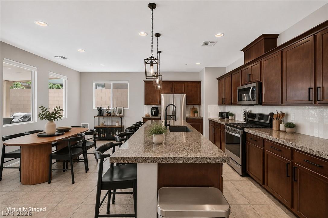 Image 2: A well-appointed kitchen features a large island a
