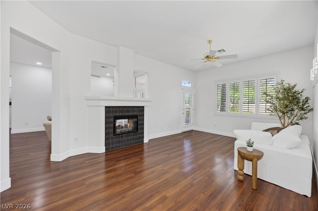 Image 3: Natural light illuminates rich hardwood flooring a