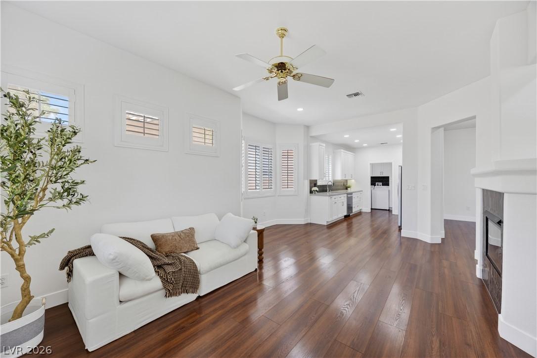 Image 4: Rich hardwood floors flow through this luminous op