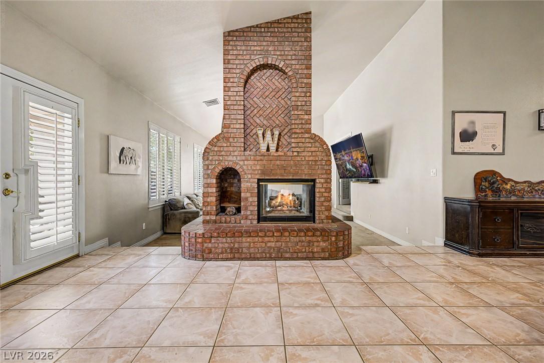 Image 3: A striking brick fireplace with an arched design a