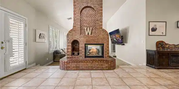 Image 3: A striking brick fireplace with an arched design a