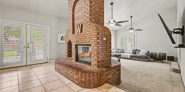 Image 4: A spacious living area showcasing a dramatic brick