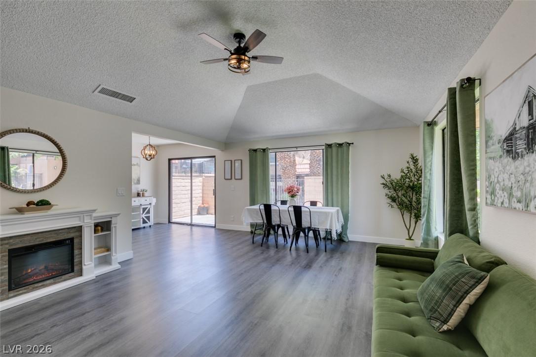 Image 1: A welcoming interior with wood flooring and a char