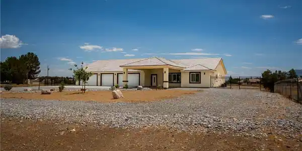 Image 2: A spacious home with an attached multi-car garage