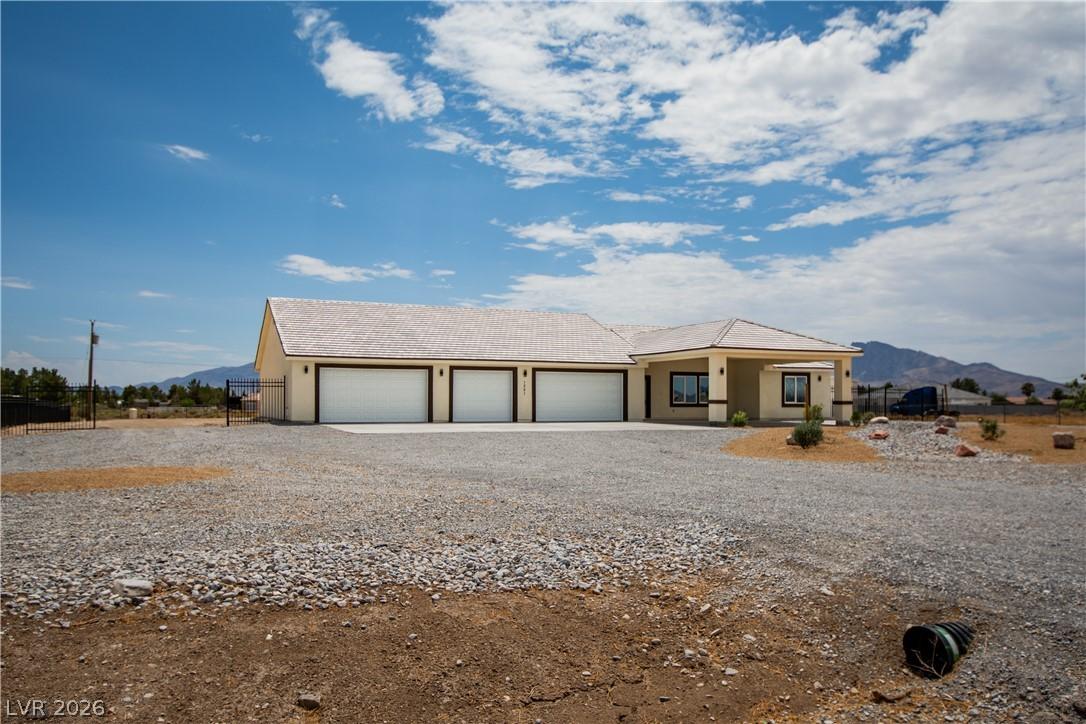 Image 3: A sprawling ranch-style home features an expansive