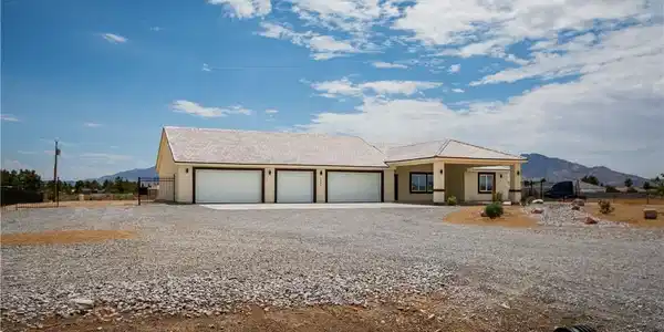 Image 3: A sprawling ranch-style home features an expansive