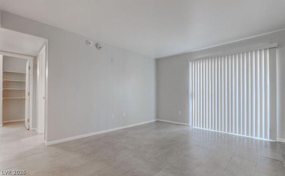Image 1: A spacious room offers ample light and modern tile