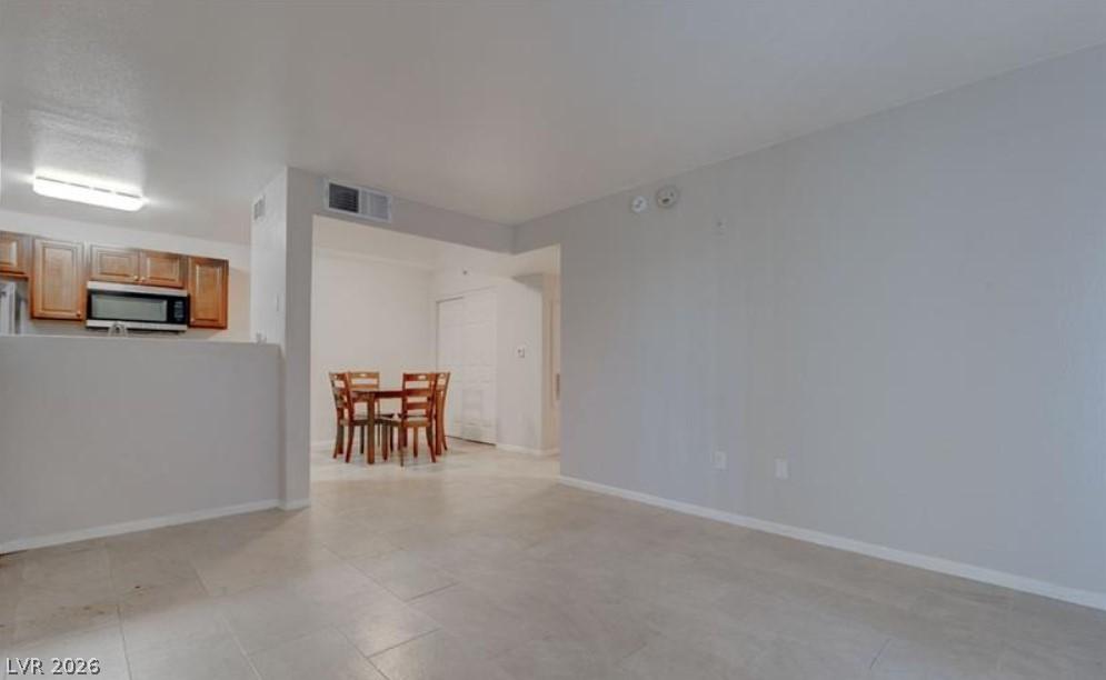 Image 3: A well-lit, open-concept living area seamlessly co