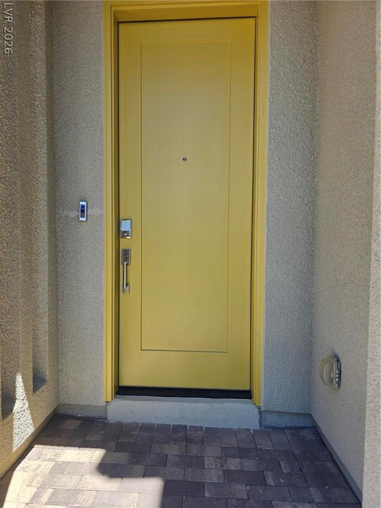 Image 2: A vibrant yellow entry door opens to a welcoming h