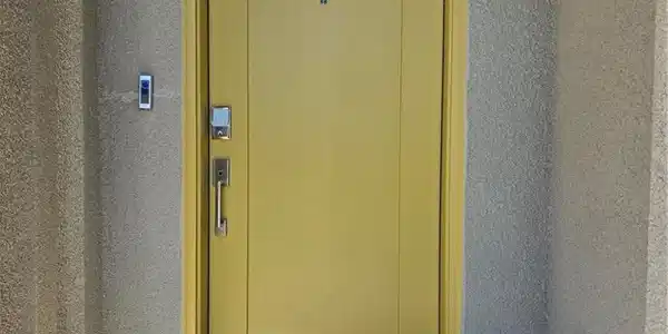 Image 2: A vibrant yellow entry door opens to a welcoming h