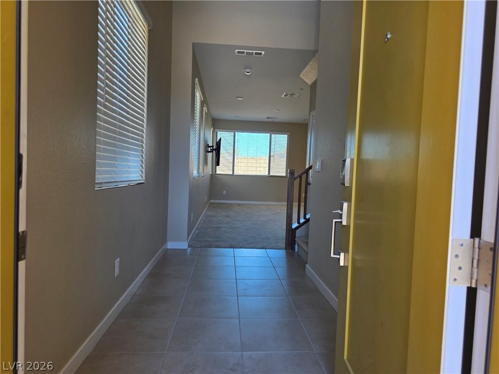 Image 3: A welcoming entryway with tile flooring leads into