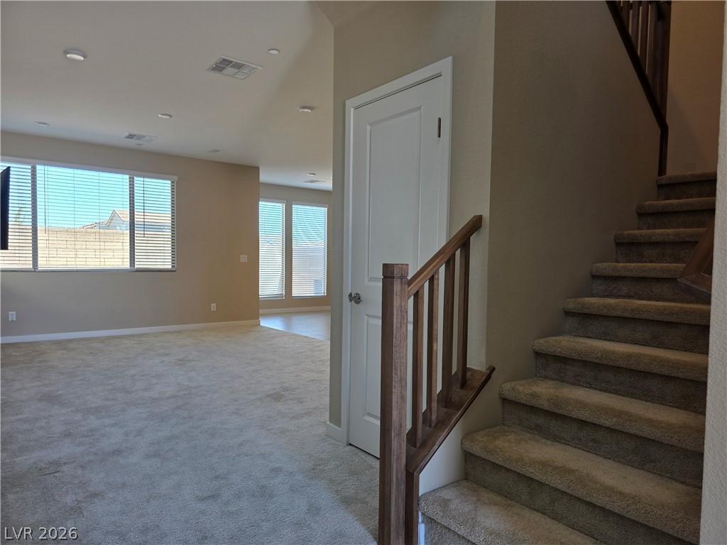 Image 4: A well-lit interior showcases plush carpeting and