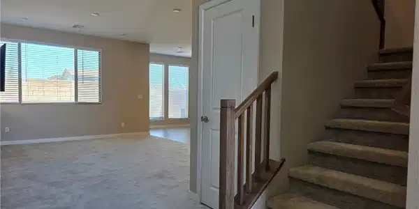 Image 4: A well-lit interior showcases plush carpeting and