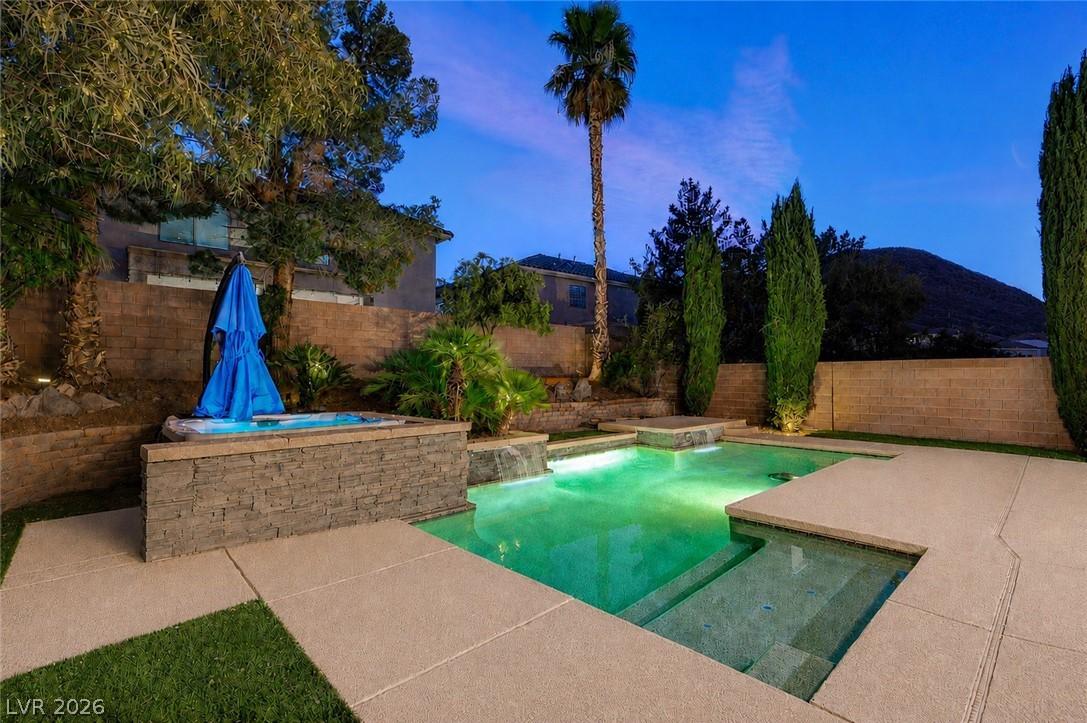 Image 2: An illuminated backyard oasis awaits, featuring a