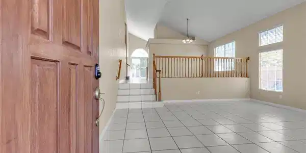 Image 4: A welcoming entry unveils high ceilings and abunda