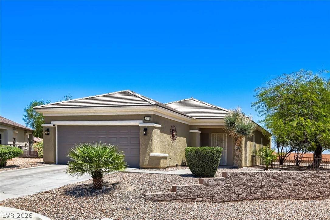 Image 3: A well-kept front yard showcases desert landscapin