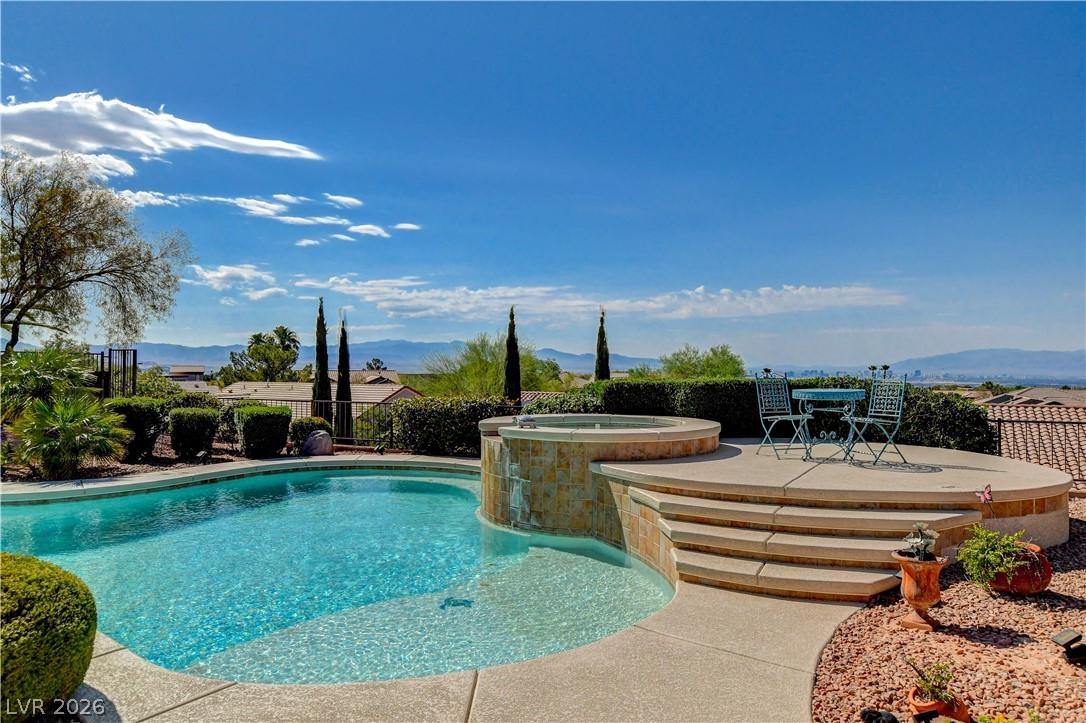 Image 1: An inviting pool and spa area boasts panoramic dis