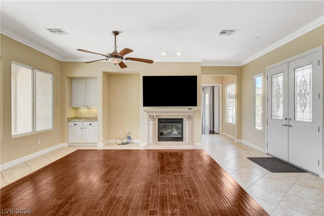 Image 3: An inviting interior offers a fireplace, wood floo