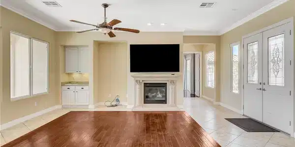Image 3: An inviting interior offers a fireplace, wood floo
