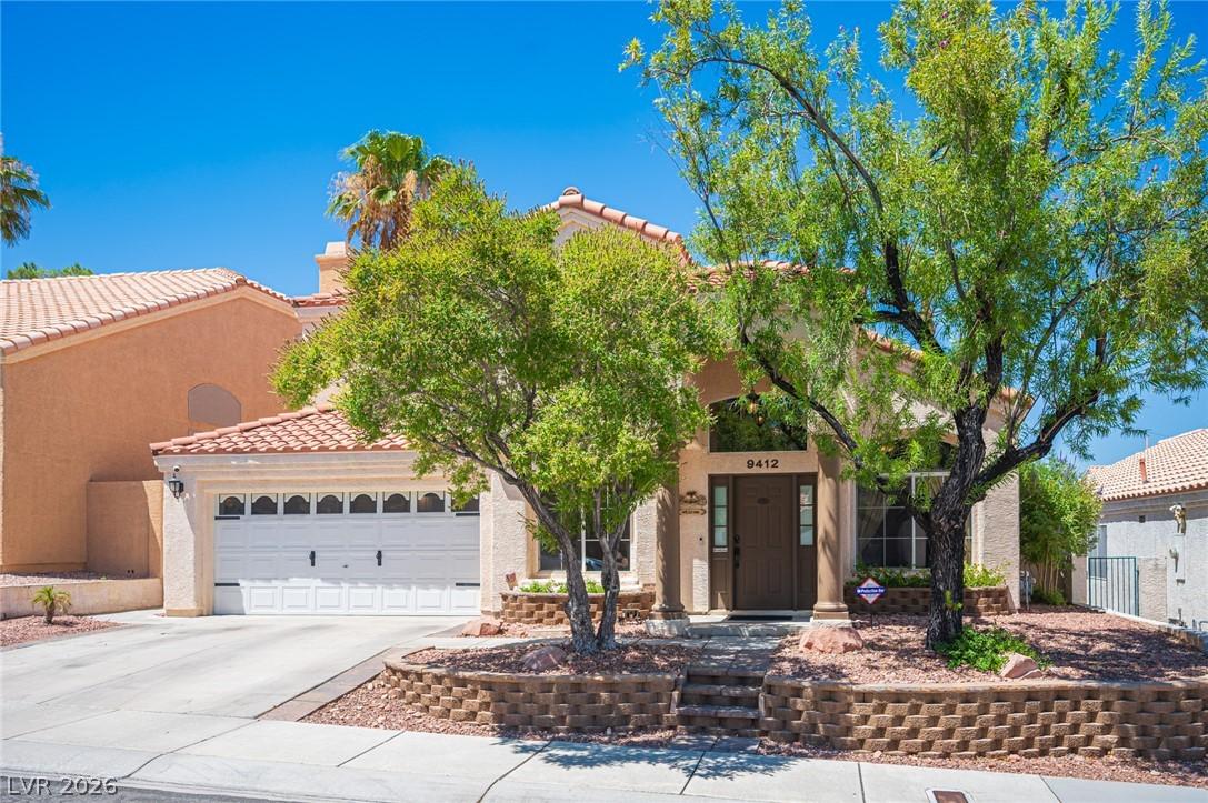 Image 4: An inviting front facade features a two-car garage