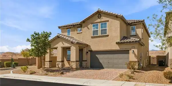 Image 2: Stone accents and a paved driveway complement this