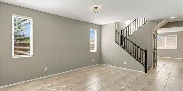 Image 4: An open layout highlights clean tile flooring alon
