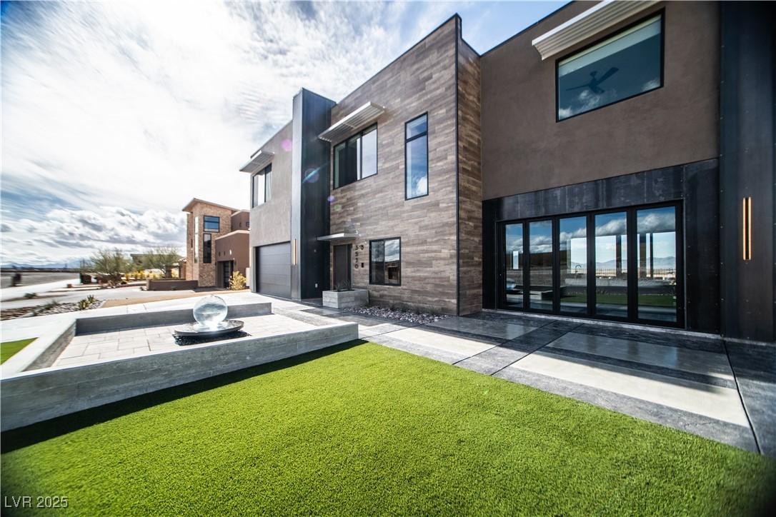 Image 2: Back of house featuring a lawn