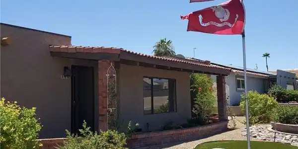 Image 2: A desert-friendly landscape with a flag pole and l