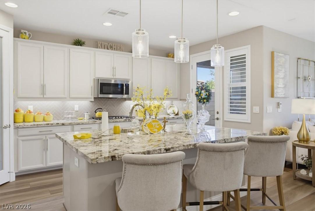 Image 1: A pristine kitchen features ample counter space, w