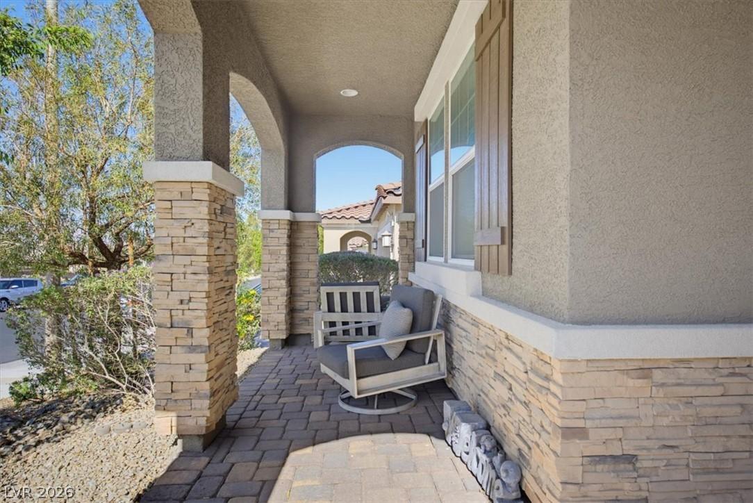 Image 3: A welcoming front porch features stone accents, st